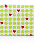 A medium-sized zipper pouch with a pattern of green tennis balls and red hearts on a white background.