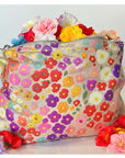 Floral-patterned pouch with colorful flowers on a white background