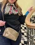 Women wearing crossbody purse in shimmer bronze gold chain link purse strap