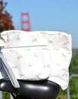 Pouch set in white with colorful bicycles pattern sitting on bike seat