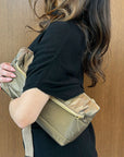 Woman wearing fold over Clutch in Shimmer Bronze Gold Zipper