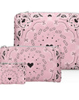 Three pink bandana print pouches with black heart on a white background