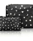 Two black pouches, one medium pouch and one mini pouch, with white star, moon and heart patterns on a white background