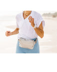 Woman Running Wearing Silver Puffer Crossbody Belt Bag Fanny Pack