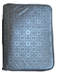 Black travel jewelry organizer with an embossed Signature Hi Print and zip-around closure.