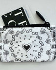 Black and white bandana patterned pouch with a card on a light gray background