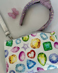 Small pouch with gemstone pattern and headband on a light gray background