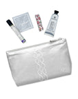 Silver cosmetic zipper pouch with toiletries laid out