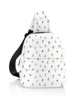 White puffer crossbody backpack with colorful dancing skiers pattern
