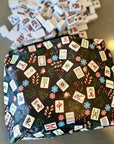 medium zip pouch in black mahjong pattern on table with mahjong pieces