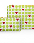 Two zippered pouches with a tennis-themed pattern of green tennis balls and red hearts on a white background.