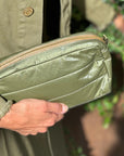 Shimmer olive green mini puffer clutch glistening in the sun