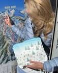 women holding skis and the bluebird ski day zipper pouch