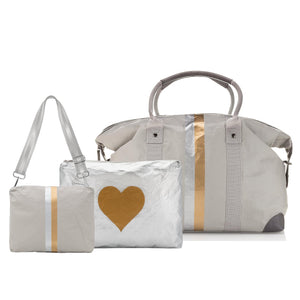 Set of Three travel bags including a Weekender duffle, jumbo zipper pouch and pouch to purse in light gray, silver and gold.