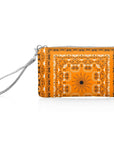 Orange bandana patterned wristlet with a silver strap on a white background