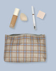 Beige and ice blue plaid cosmetic zipper pouch with makeup inside
