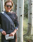 Woman in forest wearing silver fanny pack