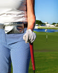 Person on golf course wearing silver layflat fanny pack belt bag