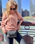 Woman on Chicago riverwalk wearing Puffer Crossbody Fanny Pack Belt Bag in Black