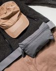 Sweater, hat, pants and Layflat Fanny Pack Belt Bag in Cool Gray on white background