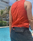 Person by pool wearing black fanny pack