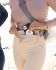 Person wearing Layflat Fanny Pack Belt Bag in Shimmer Beige