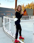 Woman roller blading with shimmer white puffer fanny pack