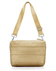 gold crossbody puffer purse handbag on white