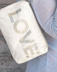 Lightweight and versatile mini padded zipper pack in shimmer white with silver "LOVE"