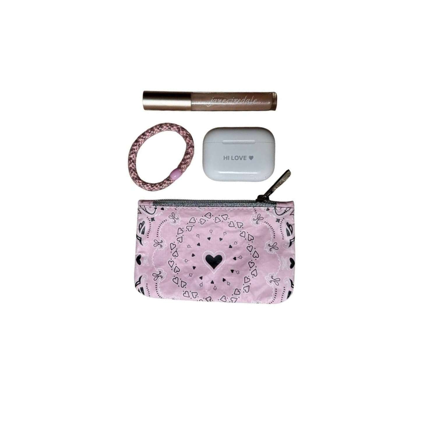 Pink bandana-patterned pouch with heart design, hair tie, and ear buds on a white background