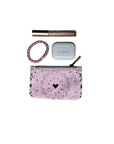 Pink bandana-patterned pouch with heart design, hair tie, and ear buds on a white background
