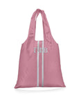 Pink tote bag with white stripes and Greek letters on a white background