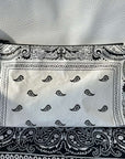 Cosmetic zipper pouch in shimmer white bandana print on black bandana and white leather background
