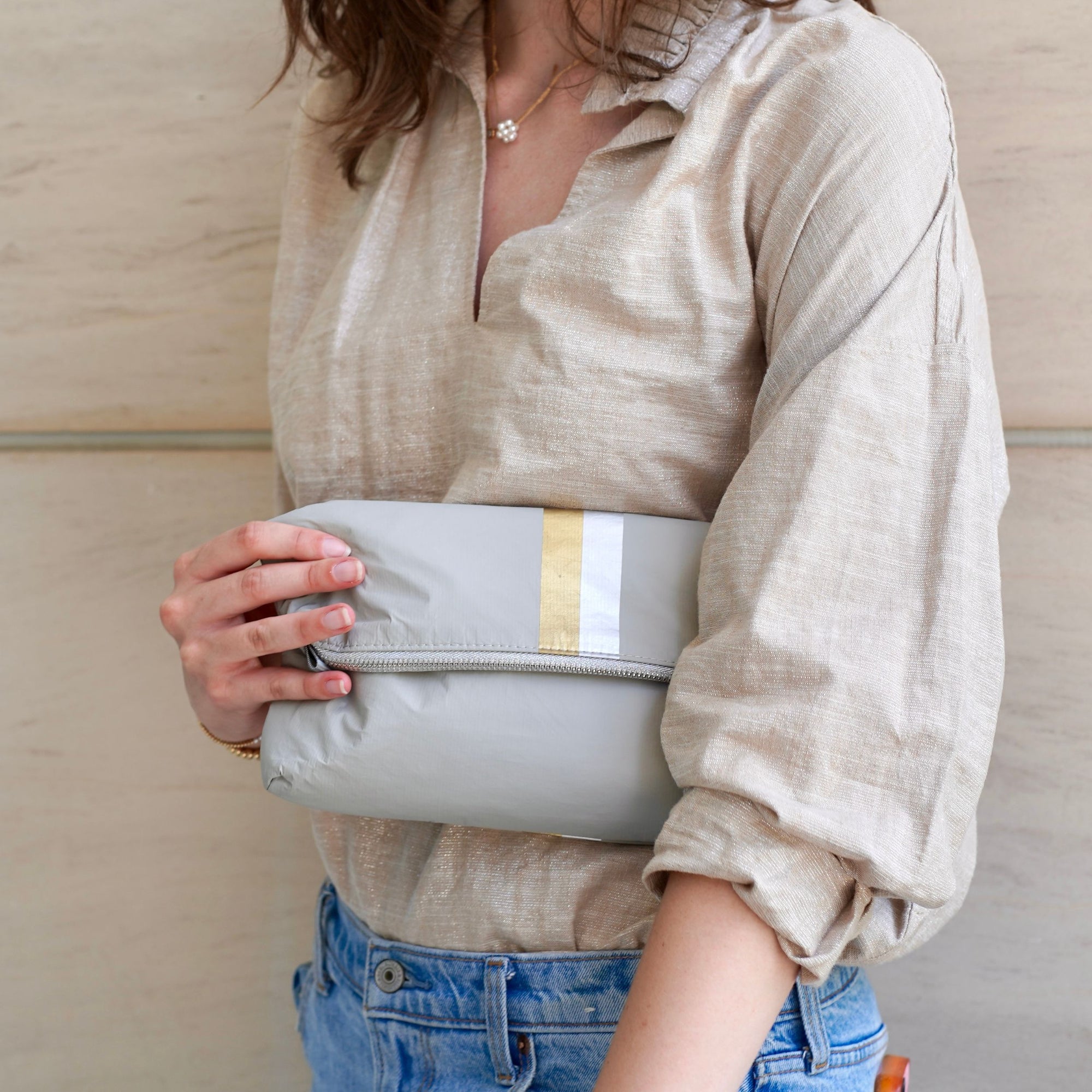 Crossbody purse in earth gray with silver and gold stripes and clutch