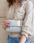 Crossbody purse in earth gray with silver and gold stripes and clutch