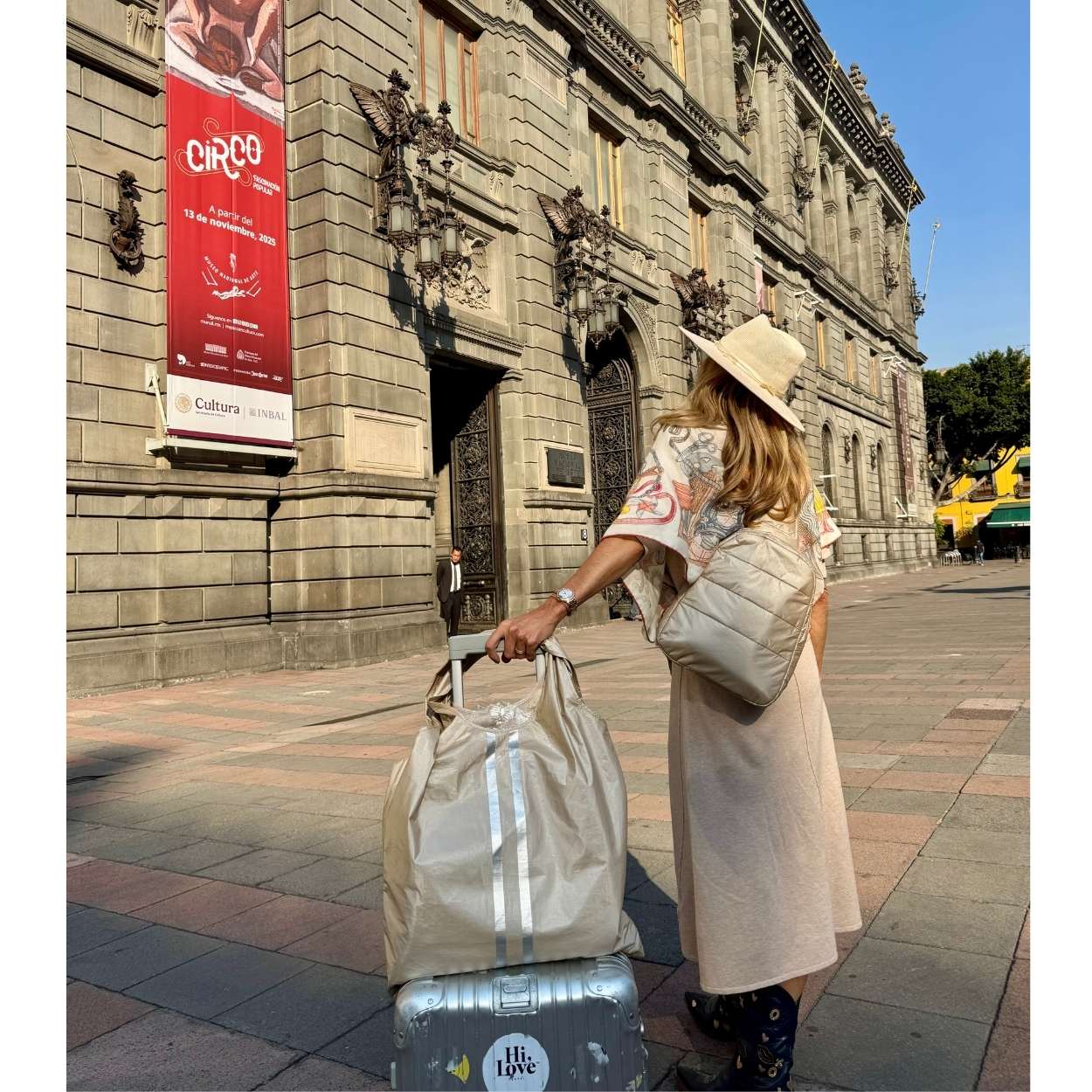 Woman with a suitcase and crossbody Backpack Sling bag in front of a museum