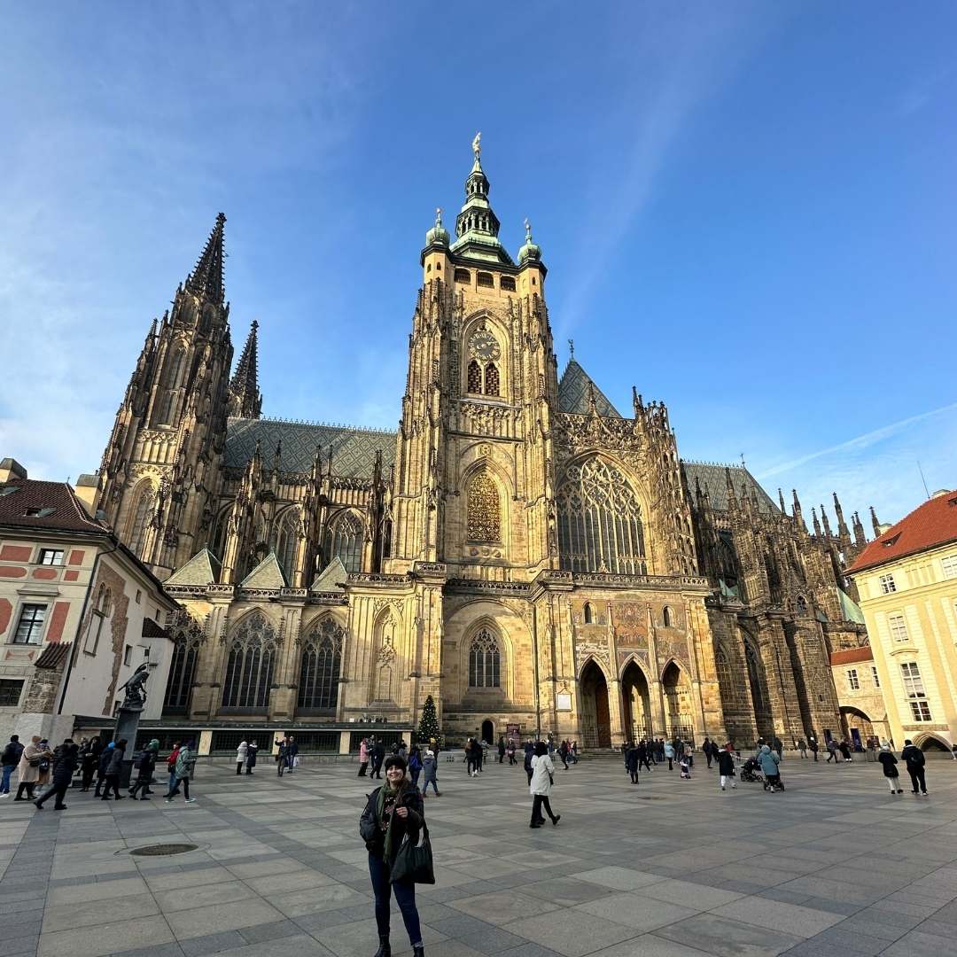 Gothic cathedral background in Prague with girl holding a black tote