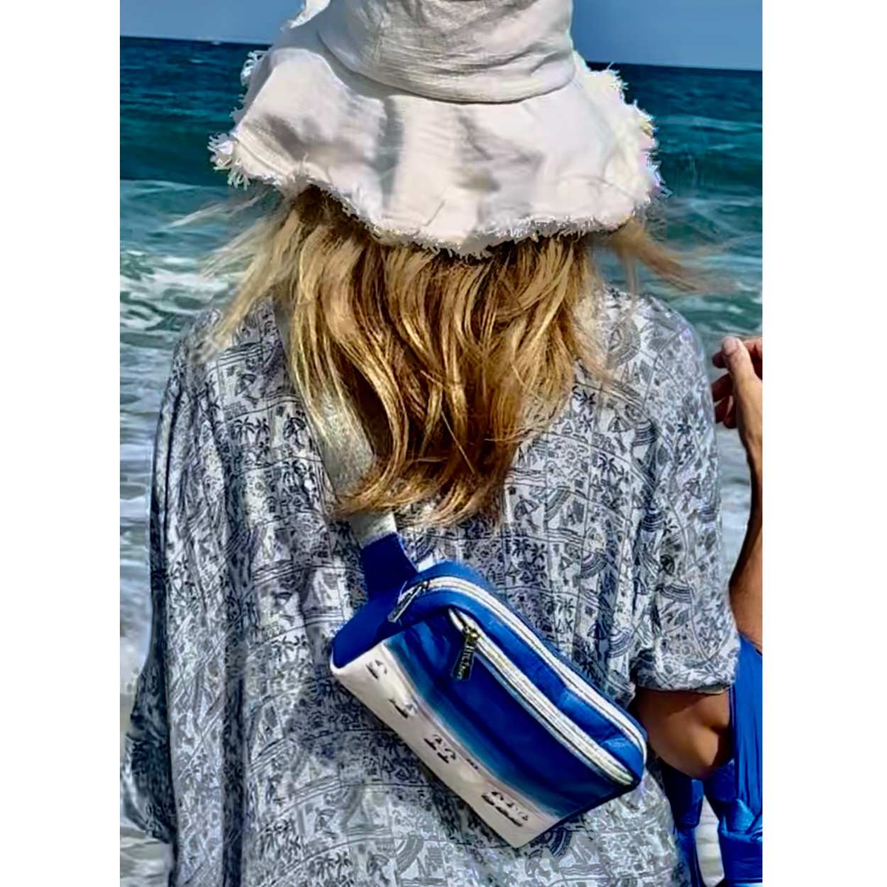 Woman by the water wearing Puffer Crossbody Fanny Pack Belt Bag with Beach Scene Print