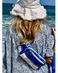Woman by the water wearing Puffer Crossbody Fanny Pack Belt Bag with Beach Scene Print