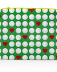 Medium Zipper Pouch with green background, white golf balls and red hearts on a white background