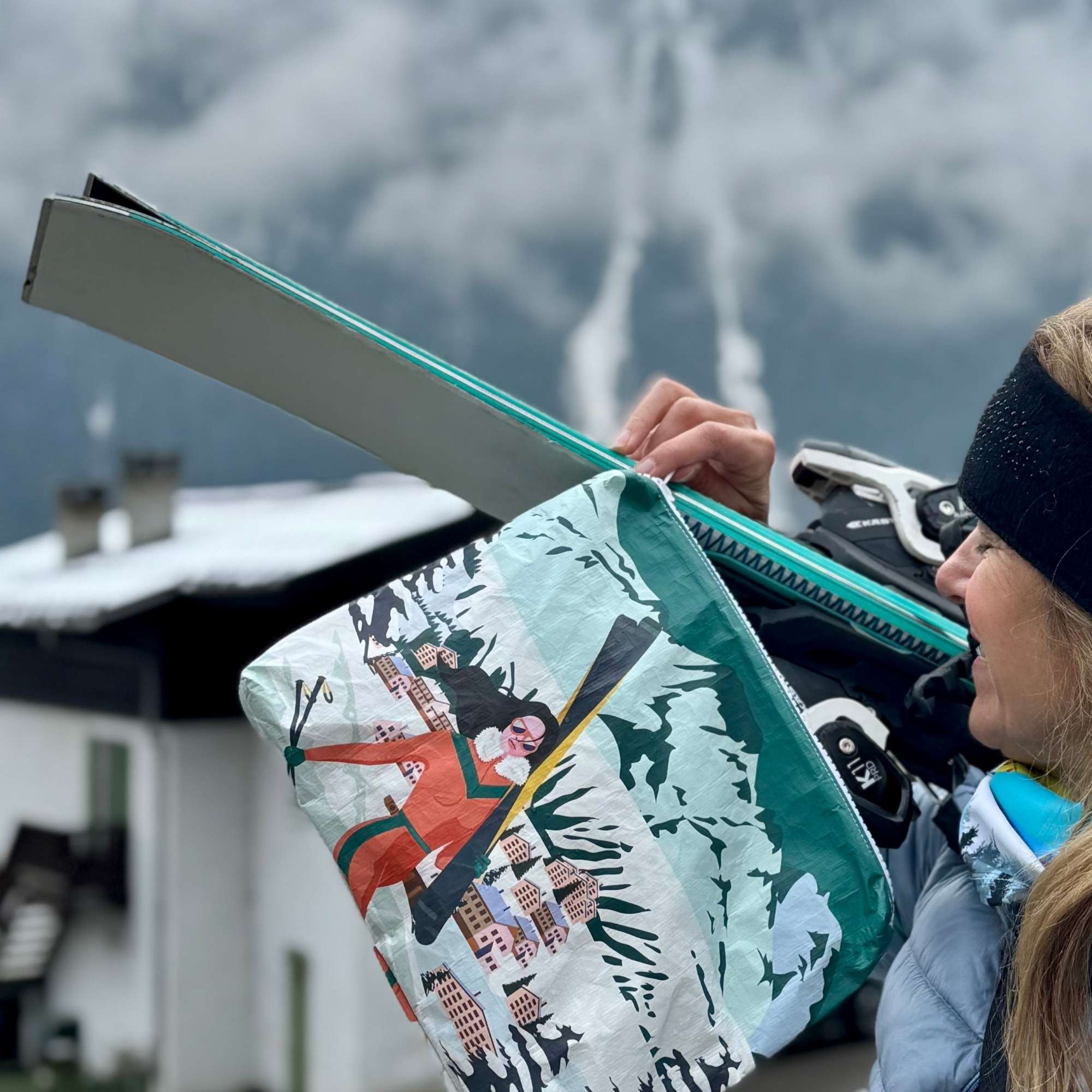 Zipper Pouch with printed scene on the bag of Woman carrying skis to her Chalet