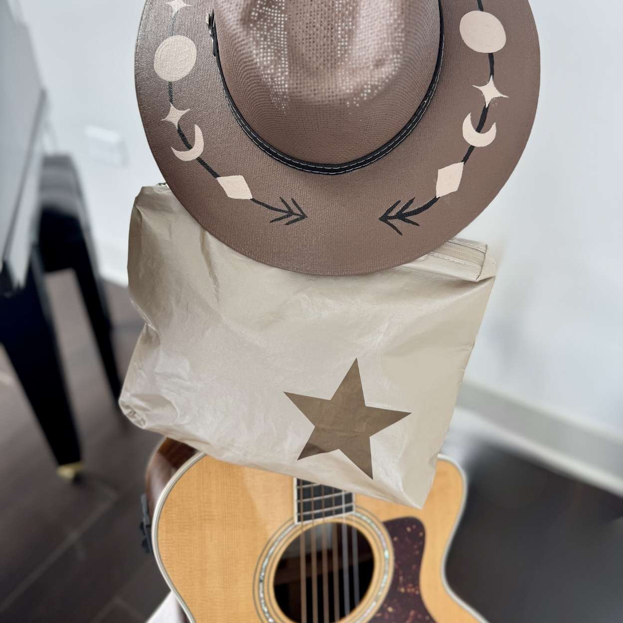 Western hat and Clutch in Beige color with star near a guitar