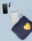 Navy pouch with gold heart, phone, notebook, lipstick, and pen on a light blue background
