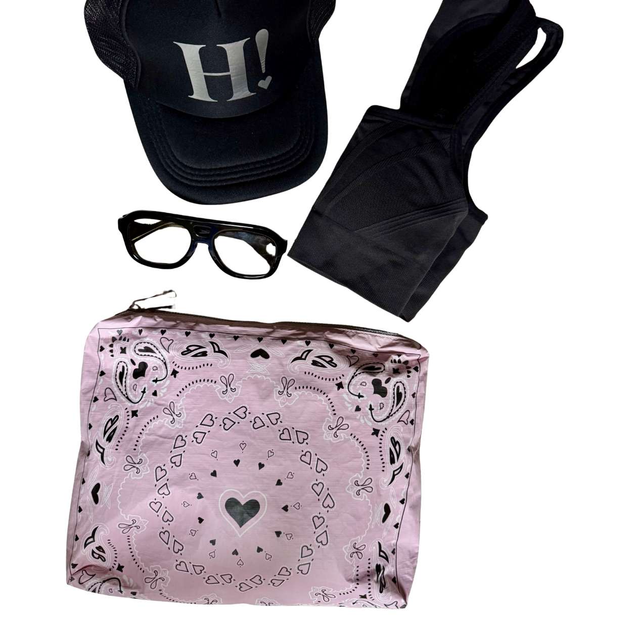 Pink Bandana Print Zipper Pouch with Black cap, sunglasses, black shorts on a white background