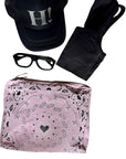 Pink Bandana Print Zipper Pouch with Black cap, sunglasses, black shorts on a white background