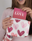 Mini Zipper Pouch with Pink Heart Print and book on LOVE being pulled out by girl