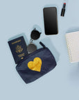 Zipper Pouch in Navy with Gold heart passport, sunglasses, phone against a blue background.