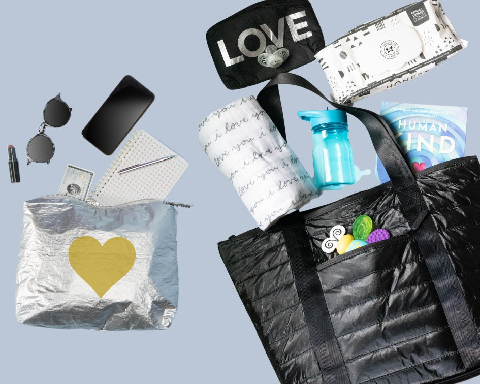 Black puffer tote with baby toys and gear on blue background
