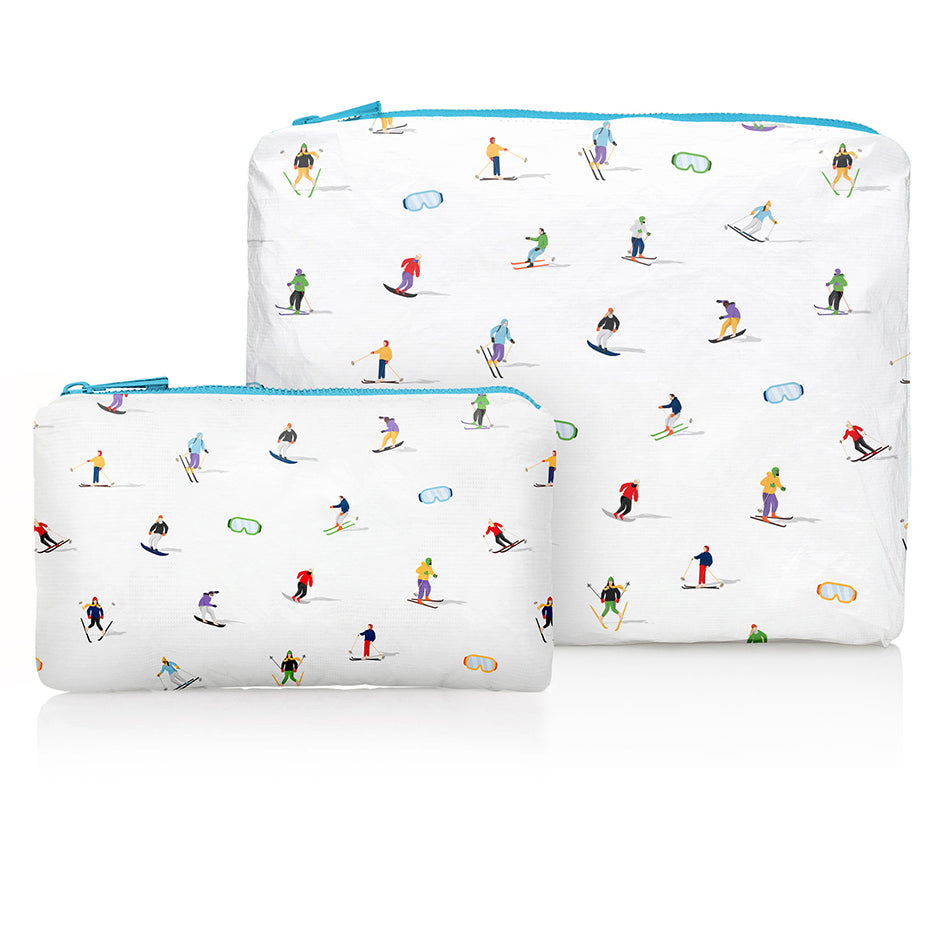 Medium and mini zipper pouch set in white with dancing skiers and ski goggles pattern and blue zipper