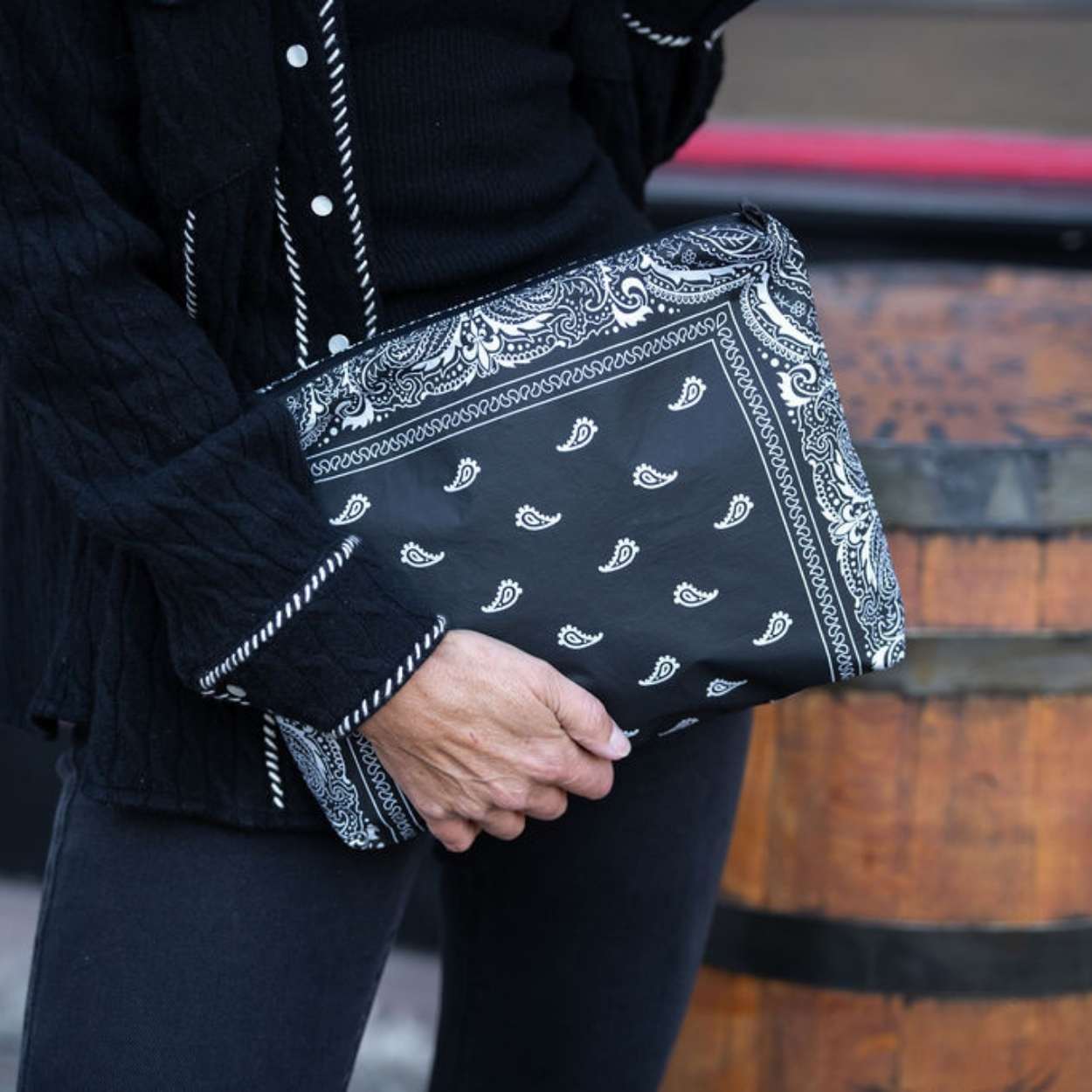 Women outdoors holding pouch for crossbody purse in black bandana print